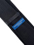 black knitted tie with white elephant embroidered design